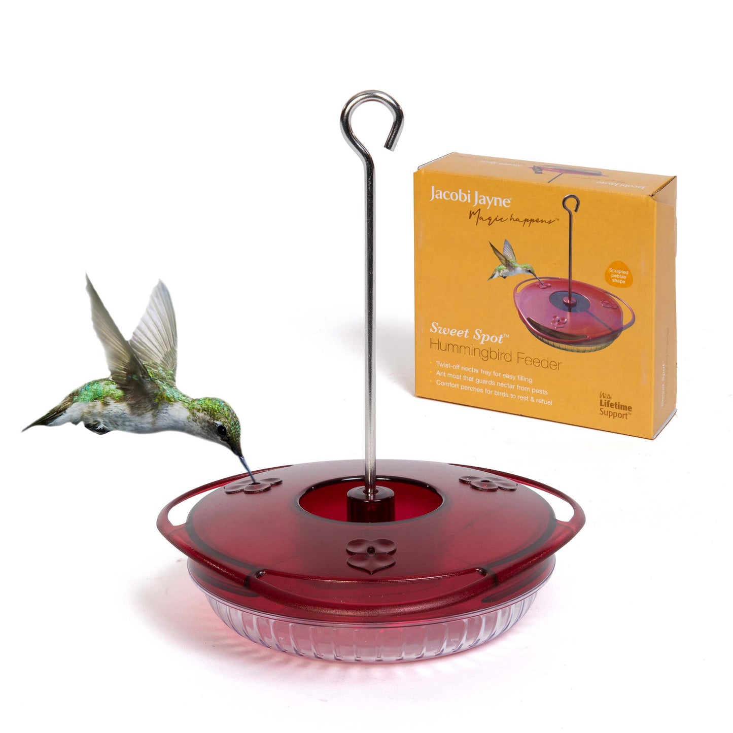 The Sweet Spot Hummingbird feeder with female ruby-throated hummingbird feeding syrup or nectar from the crimson ports. Behind is the perfectly designed box for expert storage in the winter.
