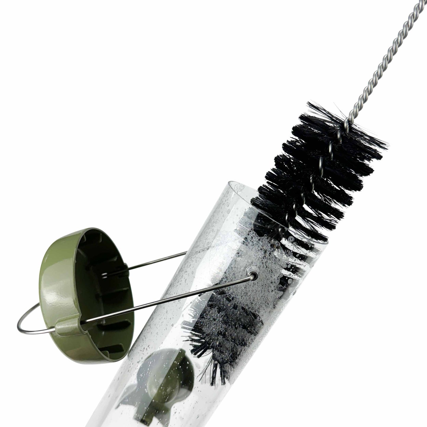 Bird feeder cleaning brush made from natural bristles and a stainless steel handle cleaning a bird seed feeder.