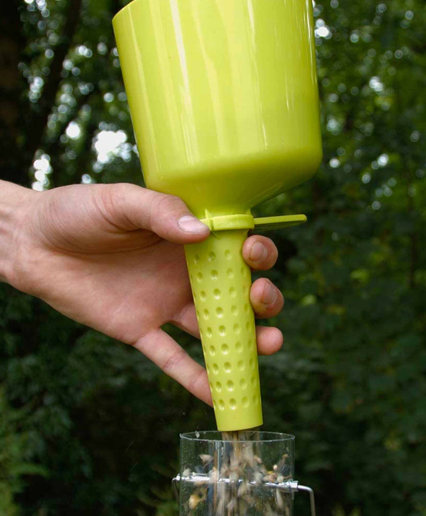 Flo bird seed scoop made from durable green plastic.